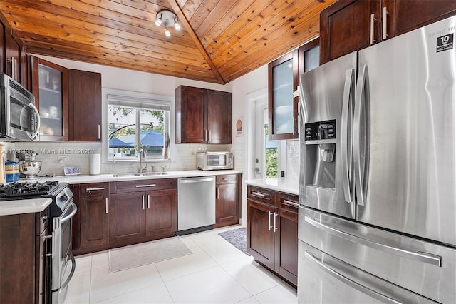 558 NE 94th St, Miami Shores, FL 33138 - kitchen featuring light countertops, a sink, tasteful backsplash, wooden ceiling, and appliances with stainless steel finishes