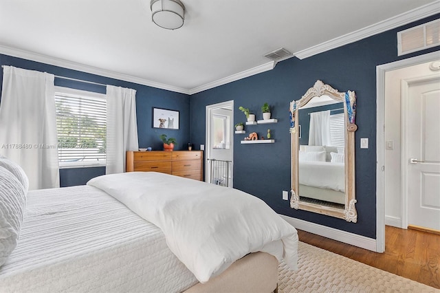 558 NE 94th St, Miami Shores, FL 33138 - bedroom featuring baseboards, crown molding, wood finished floors, and visible vents