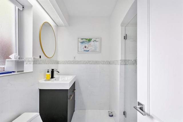 558 NE 94th St, Miami Shores, FL 33138 - bathroom featuring tile walls, wainscoting, vanity, and toilet