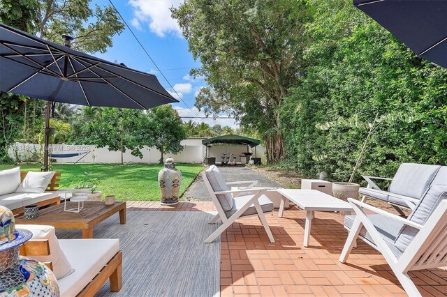 558 NE 94th St, Miami Shores, FL 33138 - wooden deck with outdoor lounge area and a patio area