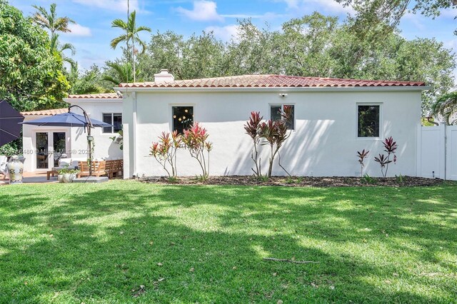 558 NE 94th St, Miami Shores, FL 33138 - back of property with a chimney, stucco siding, and a tile roof