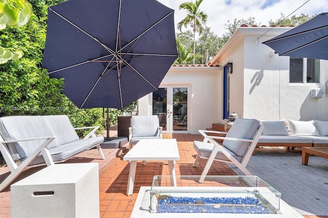 558 NE 94th St, Miami Shores, FL 33138 - view of patio with a wooden deck, an outdoor living space with a fire pit, and french doors