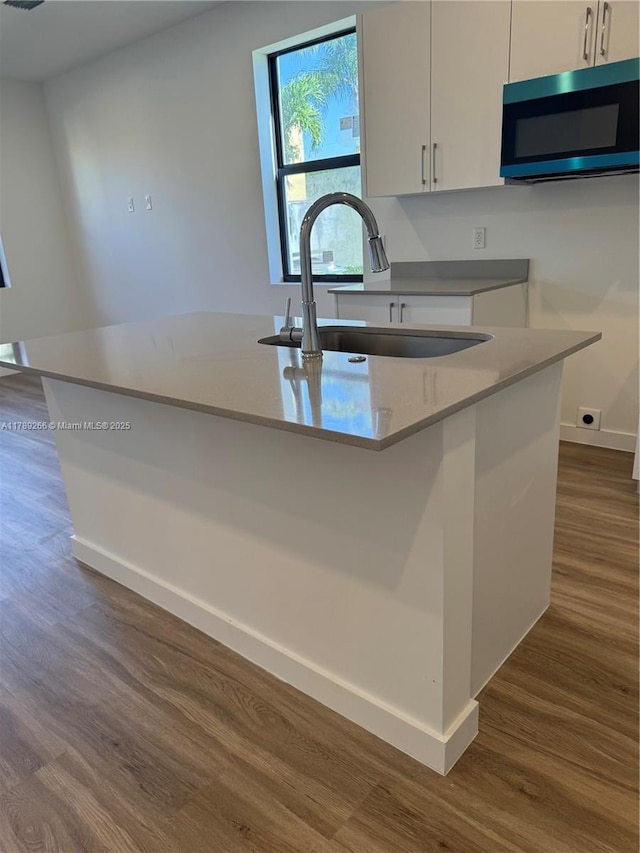 1037 NW 1st Ave Unit A, Florida City, FL 33034 - kitchen featuring a sink, dark wood-style floors, white cabinetry, and baseboards