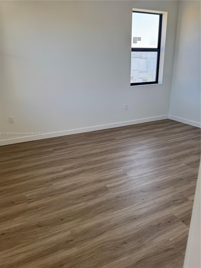 1037 NW 1st Ave Unit A, Florida City, FL 33034 - empty room featuring baseboards and dark wood-style flooring