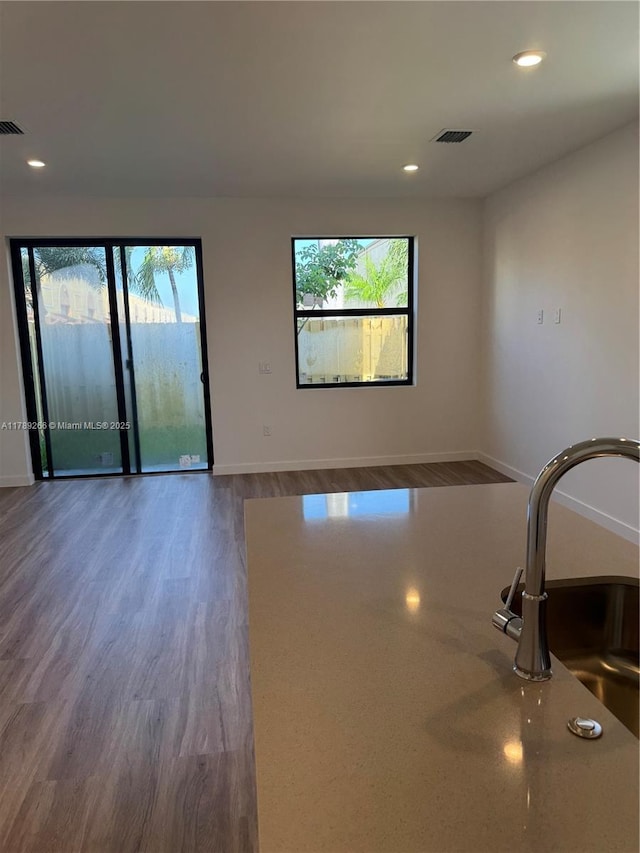 1037 NW 1st Ave Unit A, Florida City, FL 33034 - unfurnished room with healthy amount of natural light, wood finished floors, baseboards, and recessed lighting
