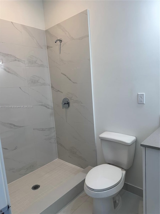 1037 NW 1st Ave Unit A, Florida City, FL 33034 - bathroom with marble look tiles, a stall shower, toilet, vanity, and baseboards