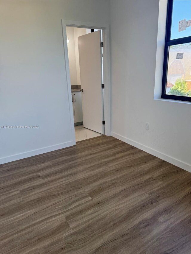 1037 NW 1st Ave Unit A, Florida City, FL 33034 - unfurnished room with baseboards and wood finished floors