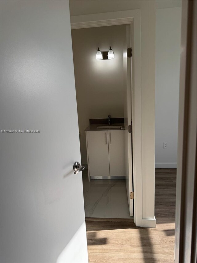 1037 NW 1st Ave Unit A, Florida City, FL 33034 - hall with a sink, baseboards, and wood finished floors