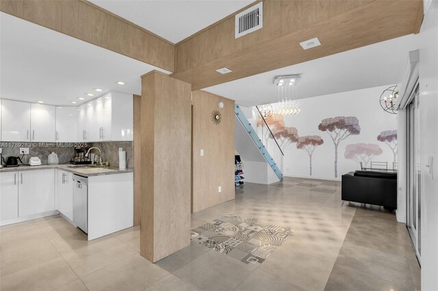 interior space featuring stairway, a sink, and visible vents