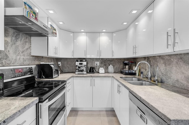 kitchen with white cabinets, dishwasher, modern cabinets, a sink, and double oven range