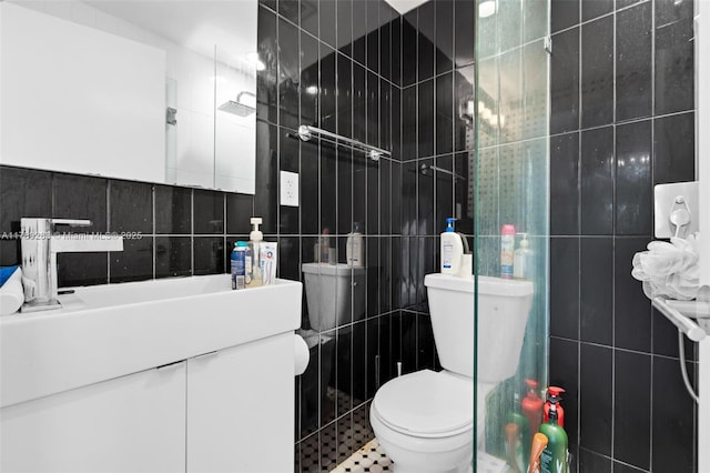bathroom with tile walls, toilet, and vanity