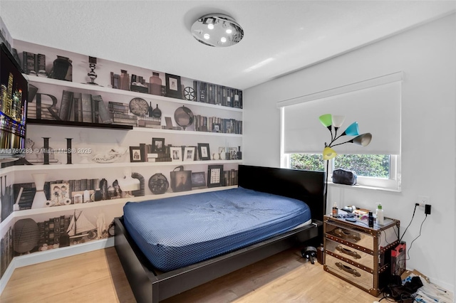 bedroom with wood finished floors