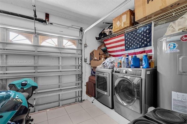 washroom featuring electric water heater, separate washer and dryer, a garage, laundry area, and light tile patterned floors