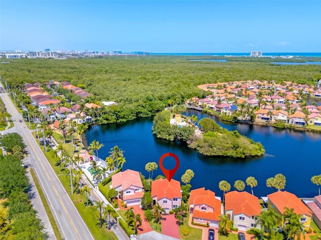 drone / aerial view with a water view and a residential view