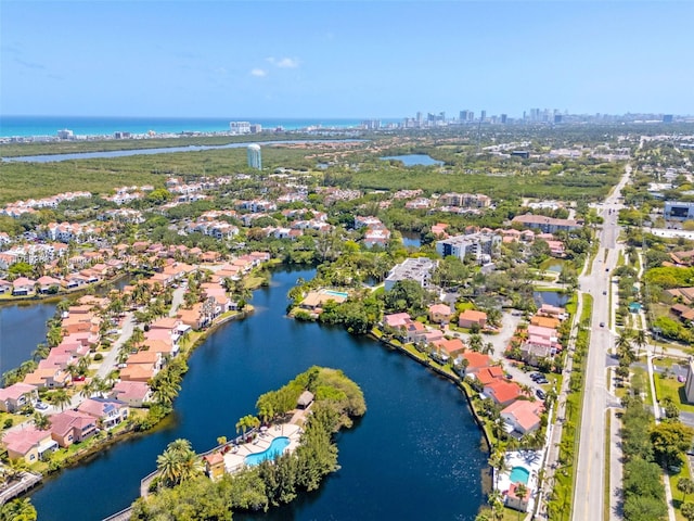 bird's eye view with a water view, a residential view, and a view of city