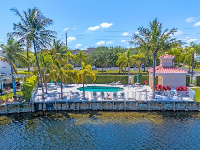 surrounding community with a patio, a water view, and fence