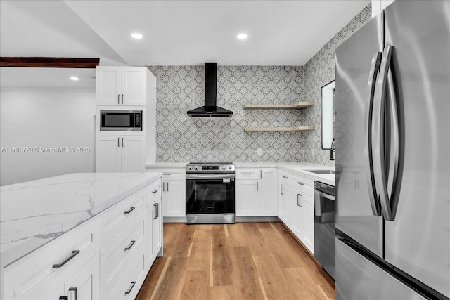 15020 NE 7th Ave, Miami, FL 33161 - kitchen with wall chimney exhaust hood, appliances with stainless steel finishes, light stone counters, and white cabinetry