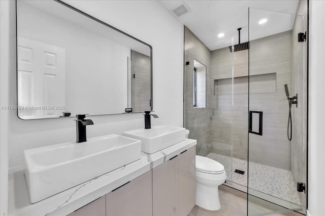 15020 NE 7th Ave, Miami, FL 33161 - bathroom with double vanity, toilet, a stall shower, and a sink