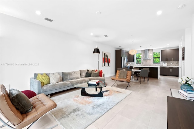living area with visible vents, recessed lighting, and light tile patterned floors