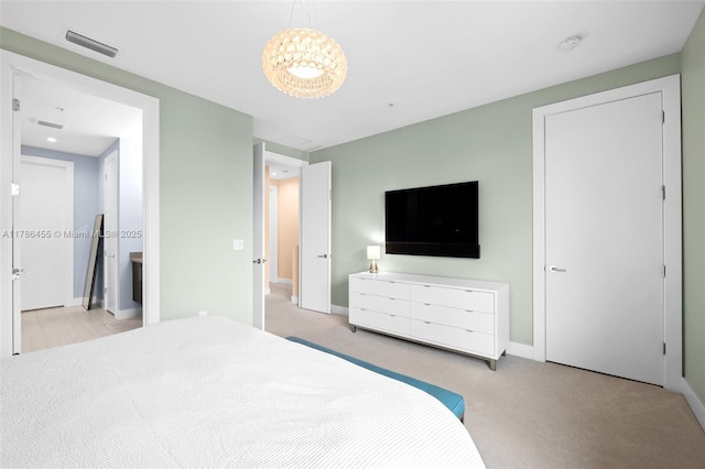 carpeted bedroom with baseboards, a chandelier, and visible vents