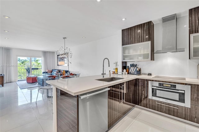 1120 99th St Unit 302, Bay Harbor Islands, FL 33154 - kitchen featuring stainless steel appliances, modern cabinets, a sink, wall chimney range hood, and light countertops