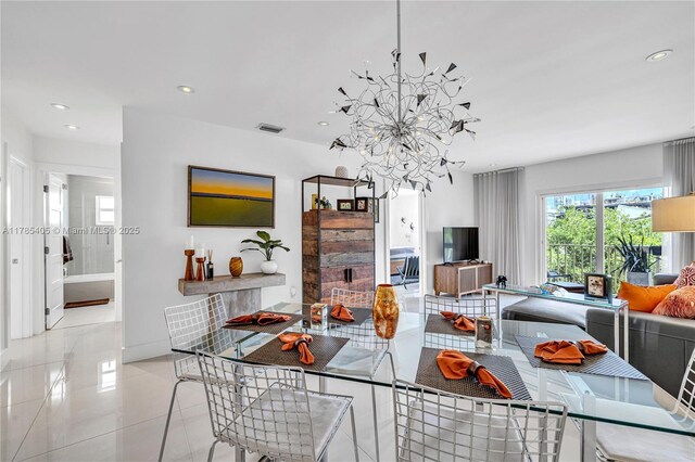 1120 99th St Unit 302, Bay Harbor Islands, FL 33154 - dining space featuring a chandelier, recessed lighting, tile patterned flooring, and a fireplace