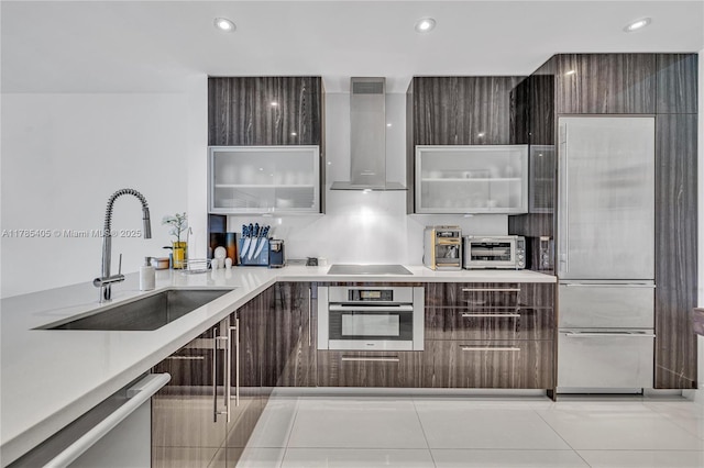 1120 99th St Unit 302, Bay Harbor Islands, FL 33154 - kitchen with modern cabinets, a sink, wall chimney range hood, stainless steel appliances, and glass insert cabinets