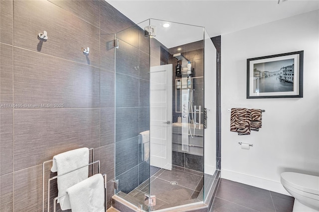 1120 99th St Unit 302, Bay Harbor Islands, FL 33154 - bathroom featuring tile patterned floors, toilet, a shower stall, and baseboards
