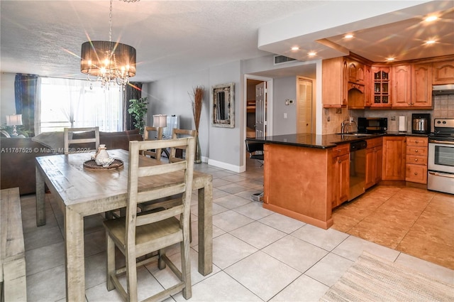 kitchen featuring decorative backsplash, brown cabinets, glass insert cabinets, an inviting chandelier, and appliances with stainless steel finishes