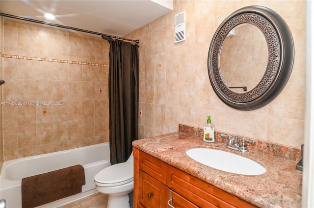bathroom featuring vanity, shower / bathtub combination with curtain, tile walls, toilet, and visible vents