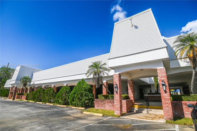 view of building exterior featuring uncovered parking