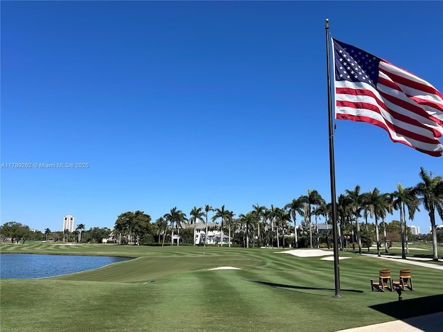 view of home's community with a water view and view of golf course