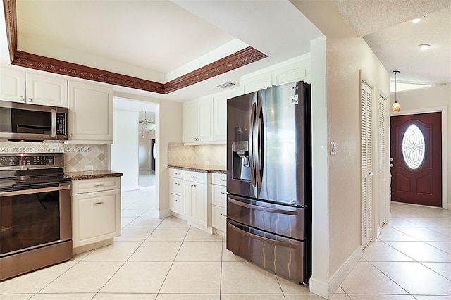 3971 NW 108th Dr, Coral Springs, FL 33065 - kitchen featuring stainless steel appliances, visible vents, light tile patterned flooring, tasteful backsplash, and white cabinetry