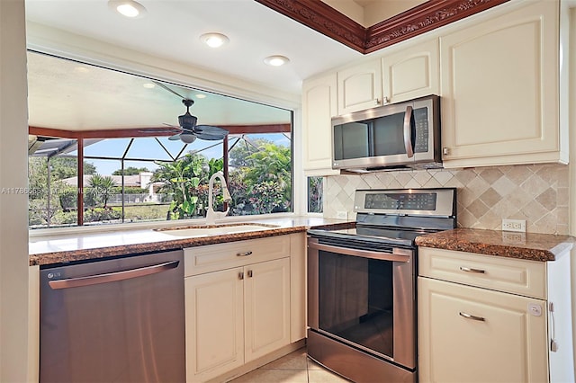 3971 NW 108th Dr, Coral Springs, FL 33065 - kitchen with stainless steel appliances, backsplash, a sink, and dark stone countertops