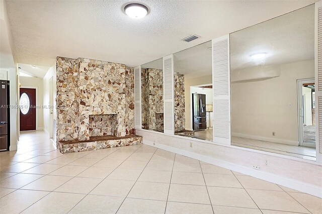 3971 NW 108th Dr, Coral Springs, FL 33065 - unfurnished living room featuring a textured ceiling, visible vents, tile patterned floors, and baseboards