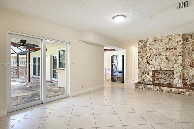 3971 NW 108th Dr, Coral Springs, FL 33065 - unfurnished living room featuring a textured ceiling, light tile patterned floors, ceiling fan, baseboards, and visible vents