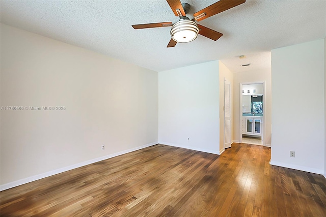 3971 NW 108th Dr, Coral Springs, FL 33065 - spare room with wood finished floors, a textured ceiling, a ceiling fan, and baseboards