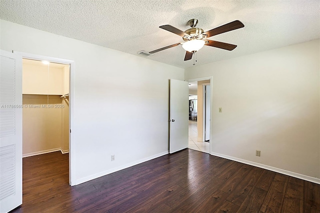 3971 NW 108th Dr, Coral Springs, FL 33065 - unfurnished bedroom with a walk in closet, a textured ceiling, wood finished floors, and visible vents