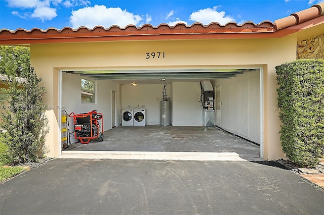 3971 NW 108th Dr, Coral Springs, FL 33065 - garage with aphalt driveway, washer and dryer, and electric water heater