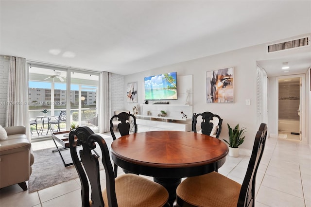 dining room with a ceiling fan, light tile patterned flooring, and visible vents