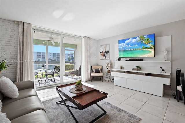 living area featuring brick wall, a ceiling fan, and light tile patterned floors