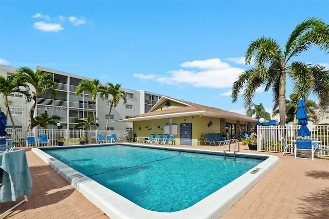 pool with fence and a patio area