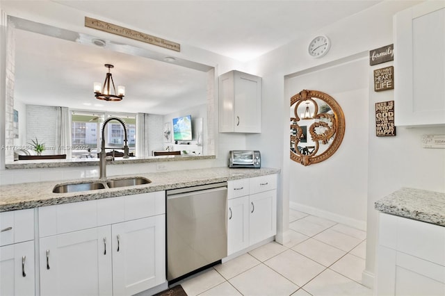 kitchen with white cabinets, stainless steel dishwasher, a sink, a chandelier, and light stone countertops