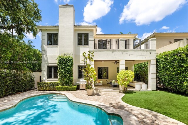 1672 Micanopy Ave, Miami, FL 33133 - rear view of property with a balcony, ceiling fan, stucco siding, a patio, and a chimney