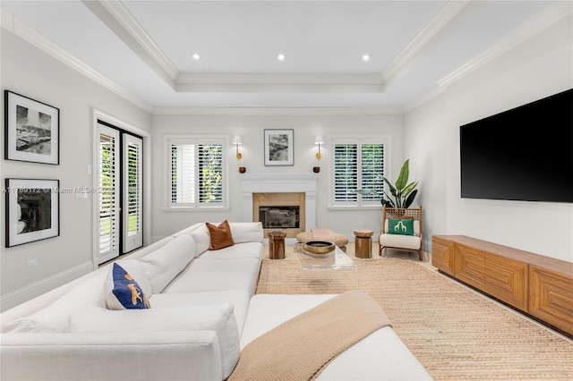 1672 Micanopy Ave, Miami, FL 33133 - living room featuring a high end fireplace, healthy amount of natural light, a raised ceiling, ornamental molding, and recessed lighting