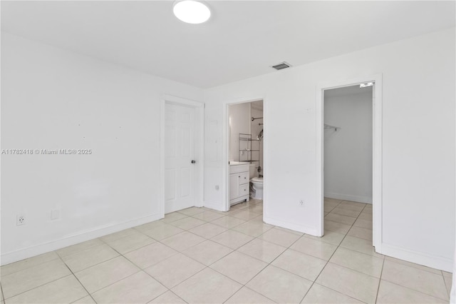 8350 SW 98 Th St, Miami, FL 33156 - unfurnished bedroom featuring visible vents, light tile patterned floors, a walk in closet, a closet, and baseboards