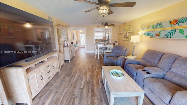9681 Sunrise Lakes Blvd Unit 209, Sunrise, FL 33322 - living room featuring baseboards, a ceiling fan, and wood finished floors