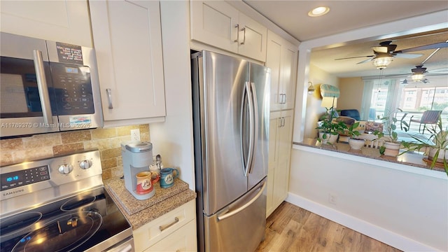 9681 Sunrise Lakes Blvd Unit 209, Sunrise, FL 33322 - kitchen with white cabinets, backsplash, light wood-type flooring, appliances with stainless steel finishes, and ceiling fan