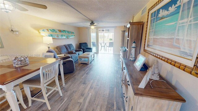 9681 Sunrise Lakes Blvd Unit 209, Sunrise, FL 33322 - living area with wood finished floors, visible vents, a textured ceiling, and ceiling fan
