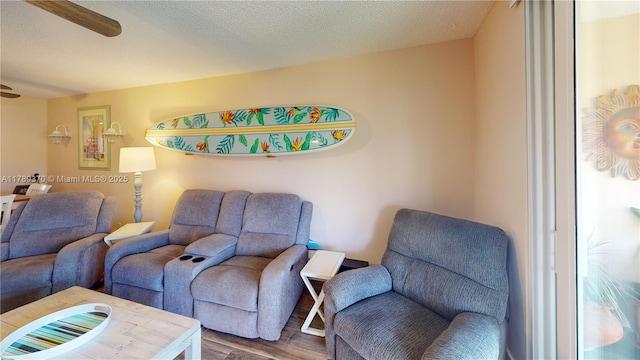 9681 Sunrise Lakes Blvd Unit 209, Sunrise, FL 33322 - living area featuring a ceiling fan, wood finished floors, and a textured ceiling